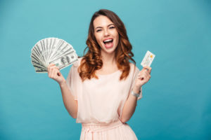 woman hoding money and credit card